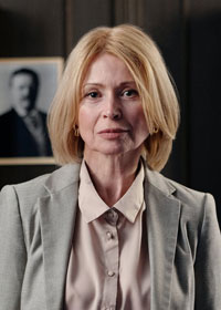 Portrait of a woman with short blonde hair looking at the camera.