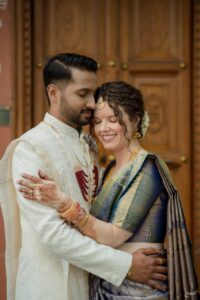 Website owner and her husband standing together and embracing.
